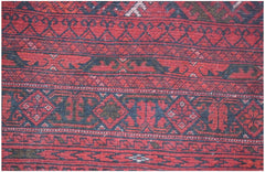 A vintage handmade Afghan Turkmen rug featuring traditional red and dark blue geometric patterns.