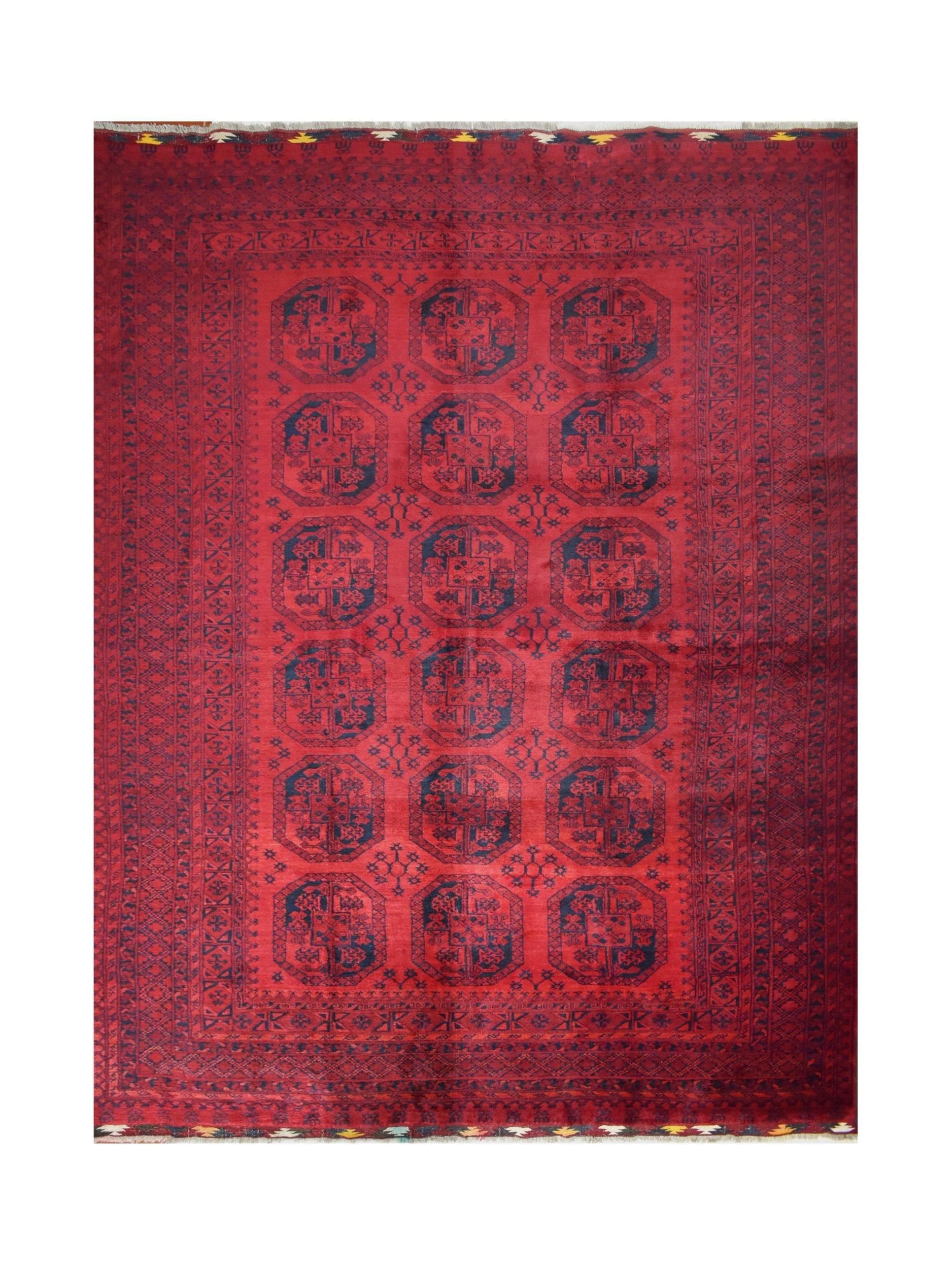 A vintage handmade Afghan Turkmen rug featuring a repeating octagonal pattern in deep red and blue.