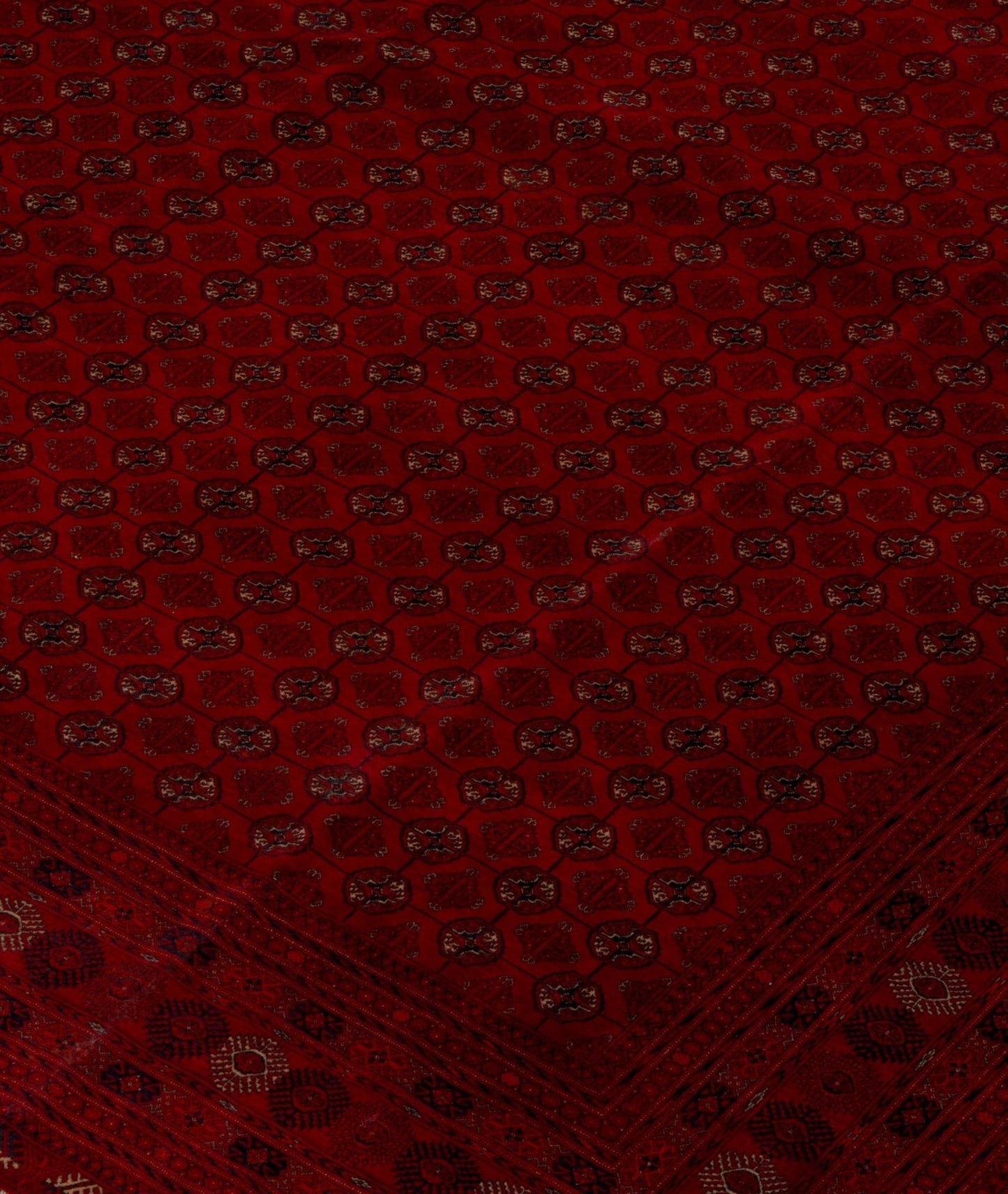 Vintage Afghan Turkmen rug with a red field and geometric patterns.