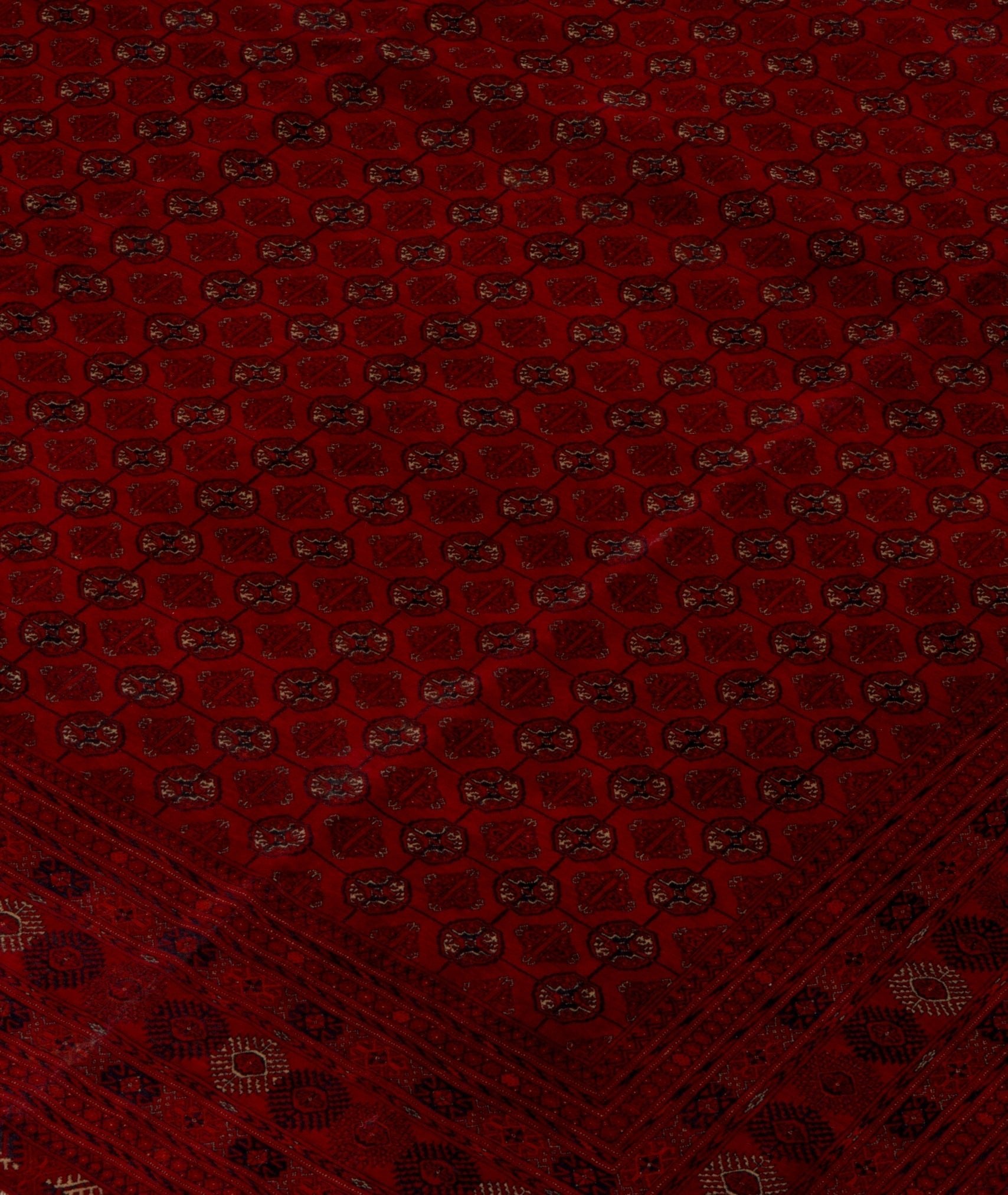 Vintage Afghan Turkmen rug with a red field and geometric patterns.