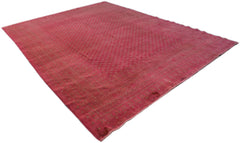 A vintage Afghan Turkmen rug featuring a geometric pattern in shades of red and muted gold.