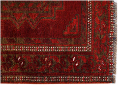 A vintage Afghan Turkmen rug featuring a geometric red and brown pattern with a fringed edge.