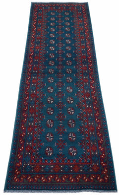 A handmade vintage Afghan Turkmen runner rug featuring geometric patterns in teal and red.