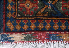 A close-up of a handmade vintage Afghan Turkmen runner featuring geometric patterns in wool.