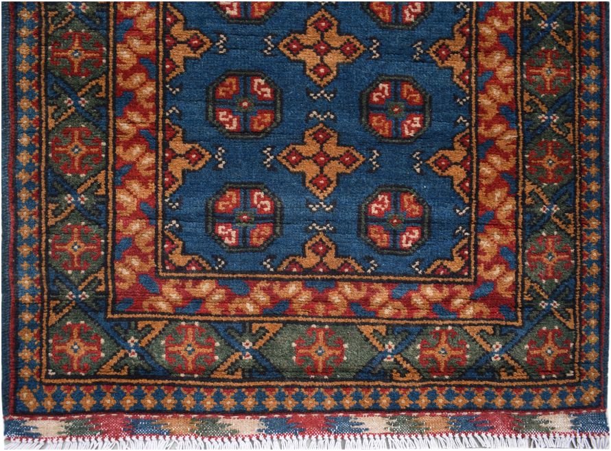 A handmade vintage Afghan Turkmen runner featuring geometric patterns in blue, red, and gold.