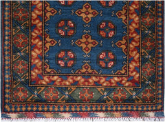 A handmade vintage Afghan Turkmen runner featuring geometric patterns in blue, red, and gold.