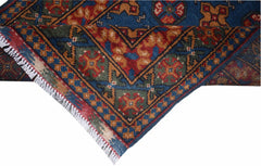 A vintage Afghan Turkmen runner featuring a geometric pattern in blue, red, and gold wool.