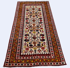 A vintage handmade Caucasian runner rug featuring a geometric floral pattern in red, yellow, and blue.