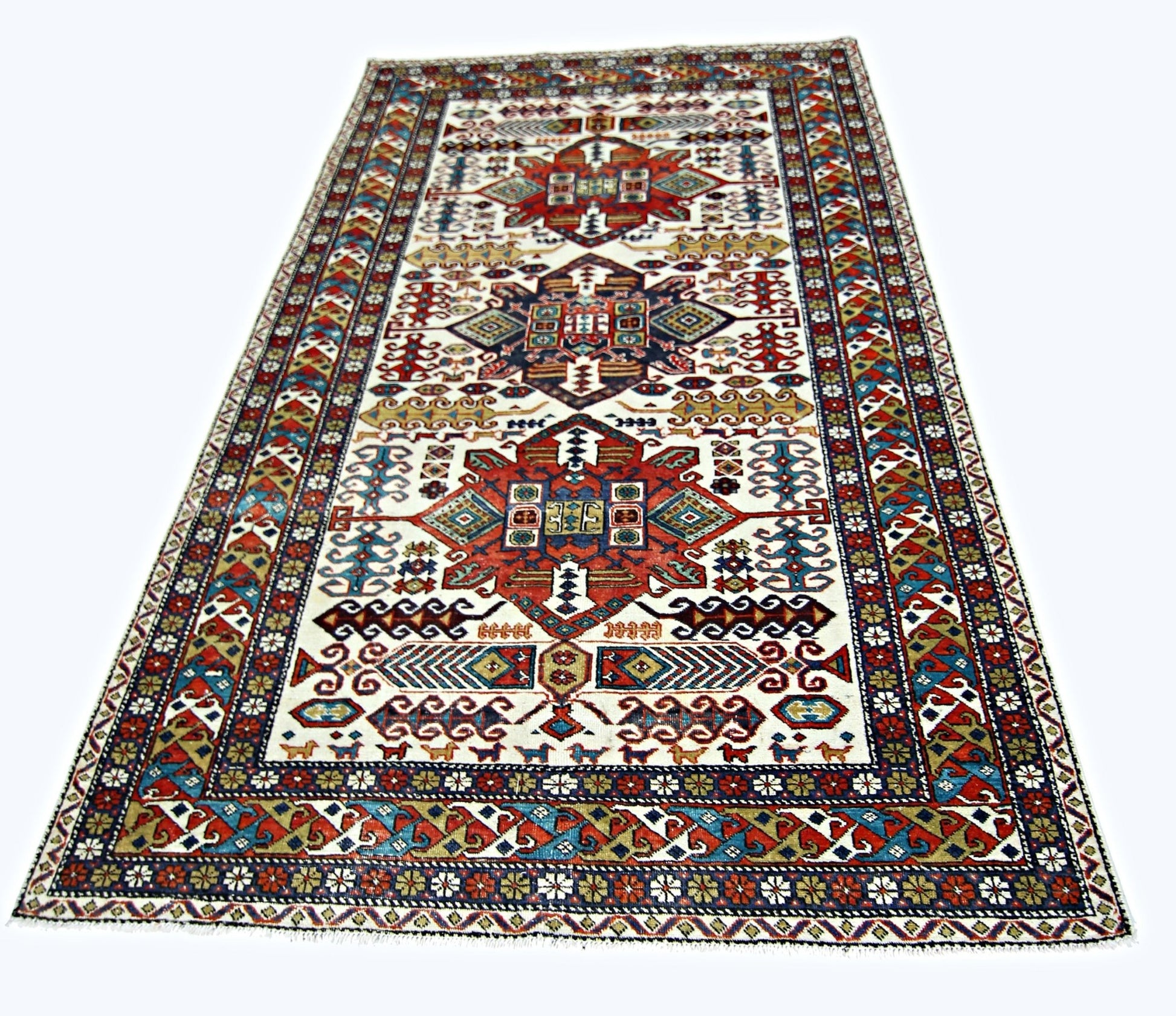 A handwoven vintage Caucasian rug featuring geometric patterns in red, blue, and cream tones.
