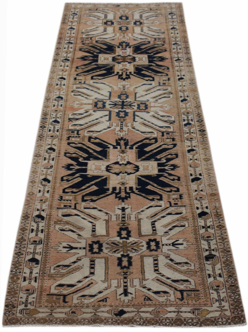 A vintage handmade Caucasian runner featuring a traditional eagle Kazak pattern in wool.