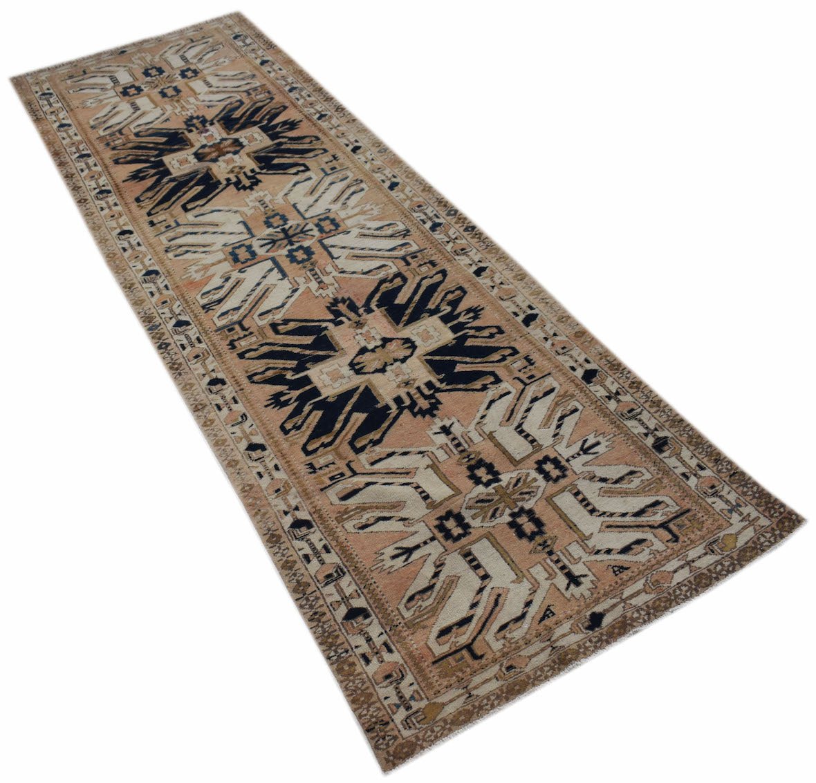 A vintage handmade Caucasian runner featuring a traditional eagle Kazak pattern in wool.