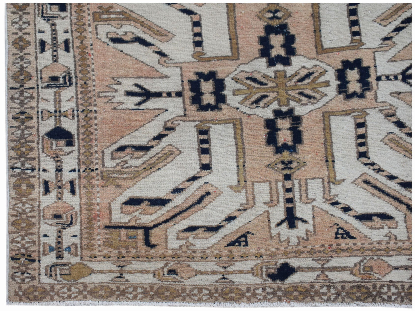 A vintage Caucasian runner featuring a traditional eagle Kazak pattern in muted earth tones.