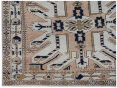 A vintage Caucasian runner featuring a traditional eagle Kazak pattern in muted earth tones.