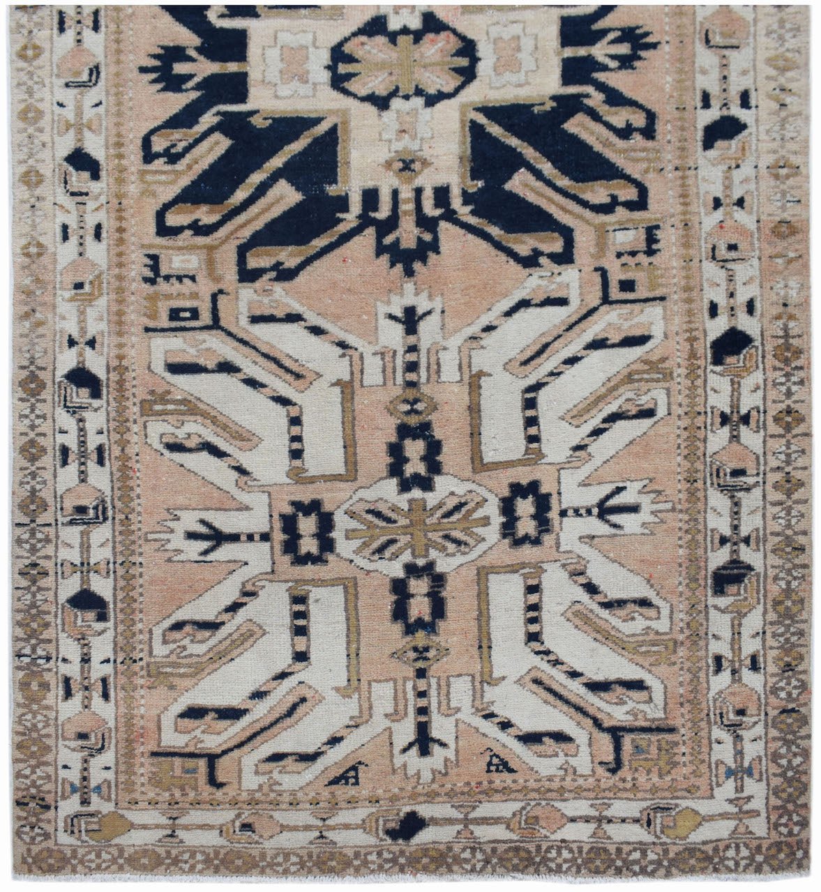 A vintage Caucasian runner featuring a traditional eagle Kazak pattern in muted earth tones.