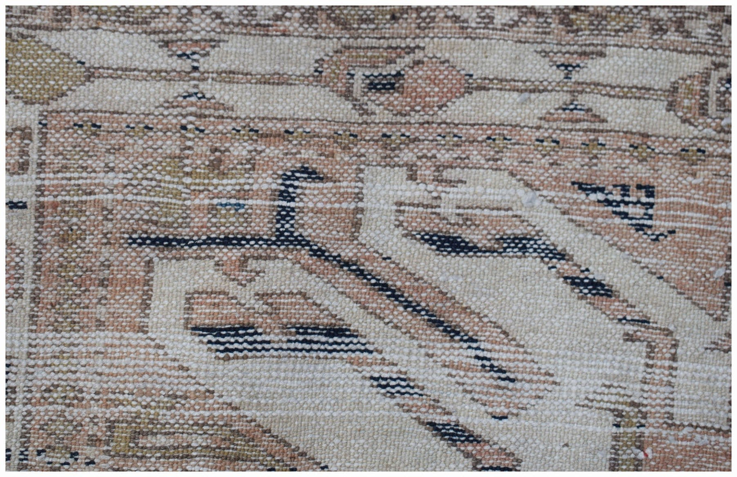 A vintage handmade Caucasian runner featuring a traditional eagle Kazak pattern in muted tones.
