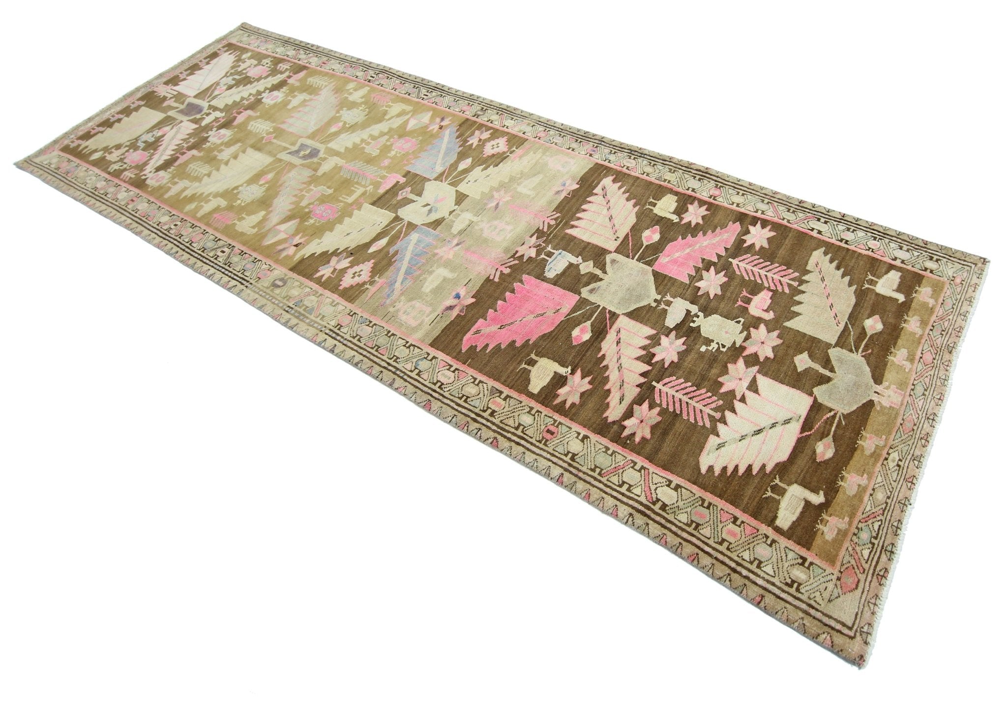 A vintage handmade Caucasian runner rug featuring a brown field with pink and cream floral motifs.