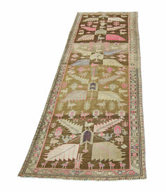 A vintage handmade Caucasian wool runner featuring a brown field with pink and white bird motifs.