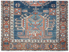 A vintage handwoven Caucasian Shirvan runner featuring a geometric blue and red medallion pattern.