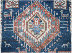 A vintage handwoven Caucasian Shirvan runner featuring a central diamond motif and animal figures.