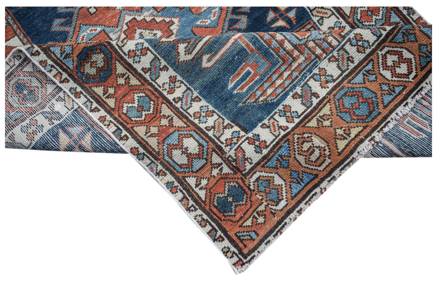 A vintage Caucasian Shirvan runner featuring a geometric pattern in blue, red, and cream tones.