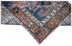 A vintage Caucasian Shirvan runner featuring a geometric pattern in blue, red, and cream tones.