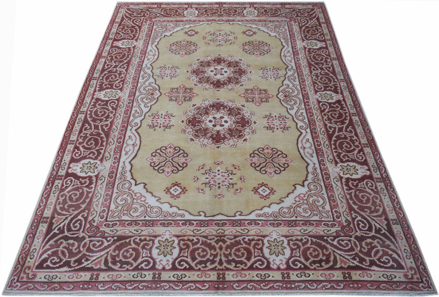 Vintage Chinese Khotan rug with a central medallion and intricate border.