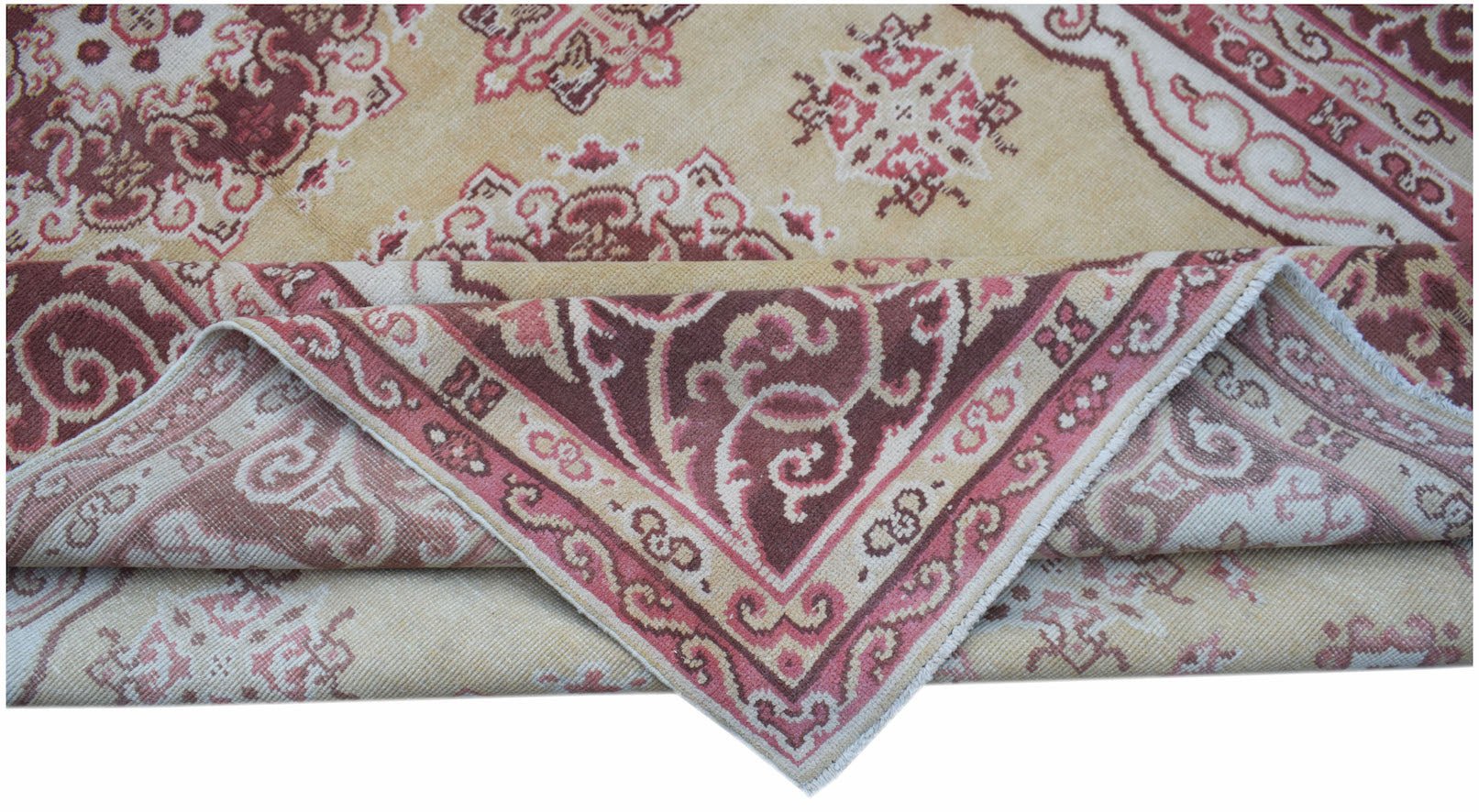 A vintage Chinese Khotan rug featuring a floral medallion pattern in shades of red and beige.