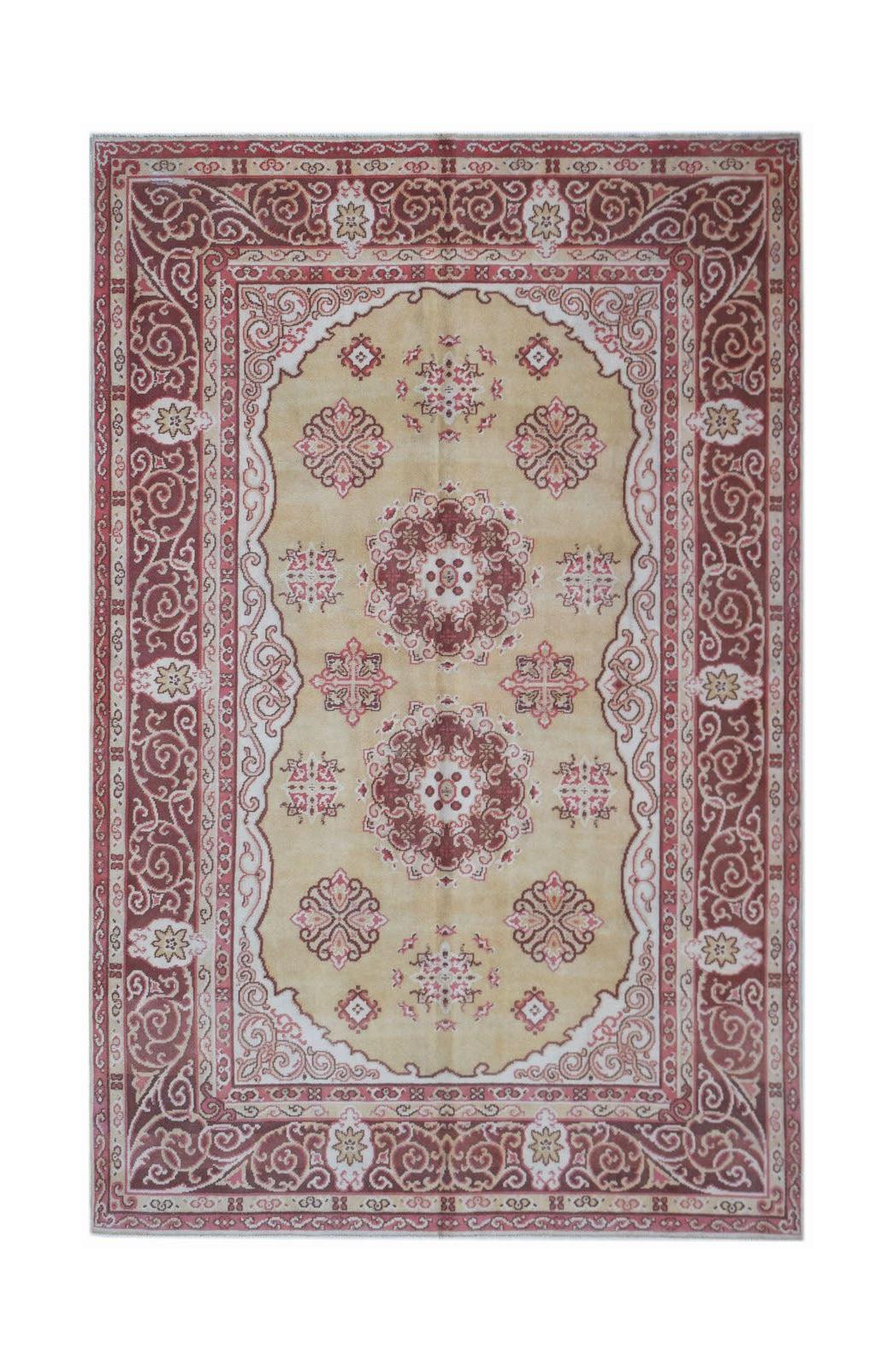 A vintage handwoven Chinese Khotan rug featuring a tan field with red floral medallions and borders.