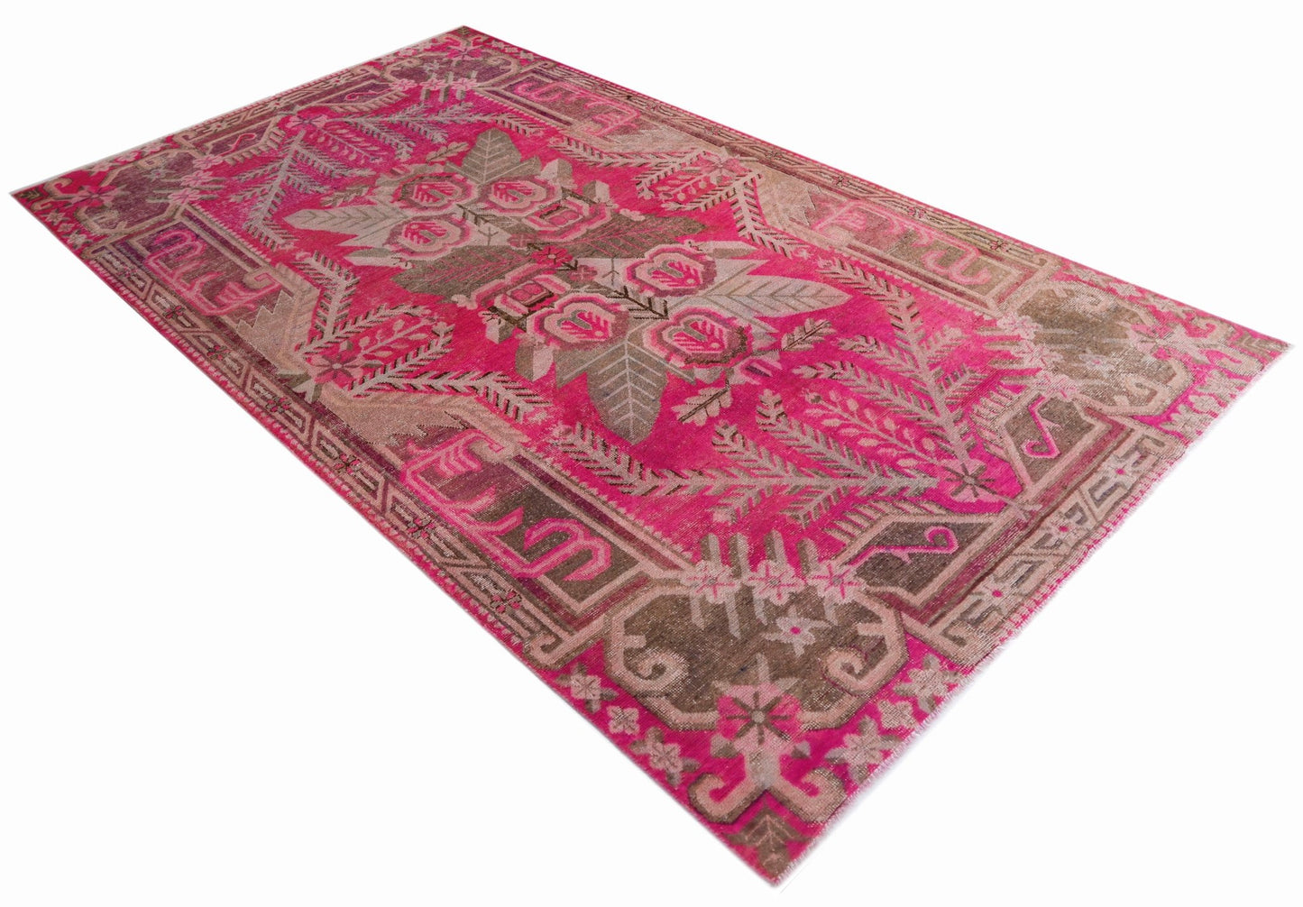 A vintage handwoven Khotan rug featuring a vibrant pink field with an intricate floral pattern.