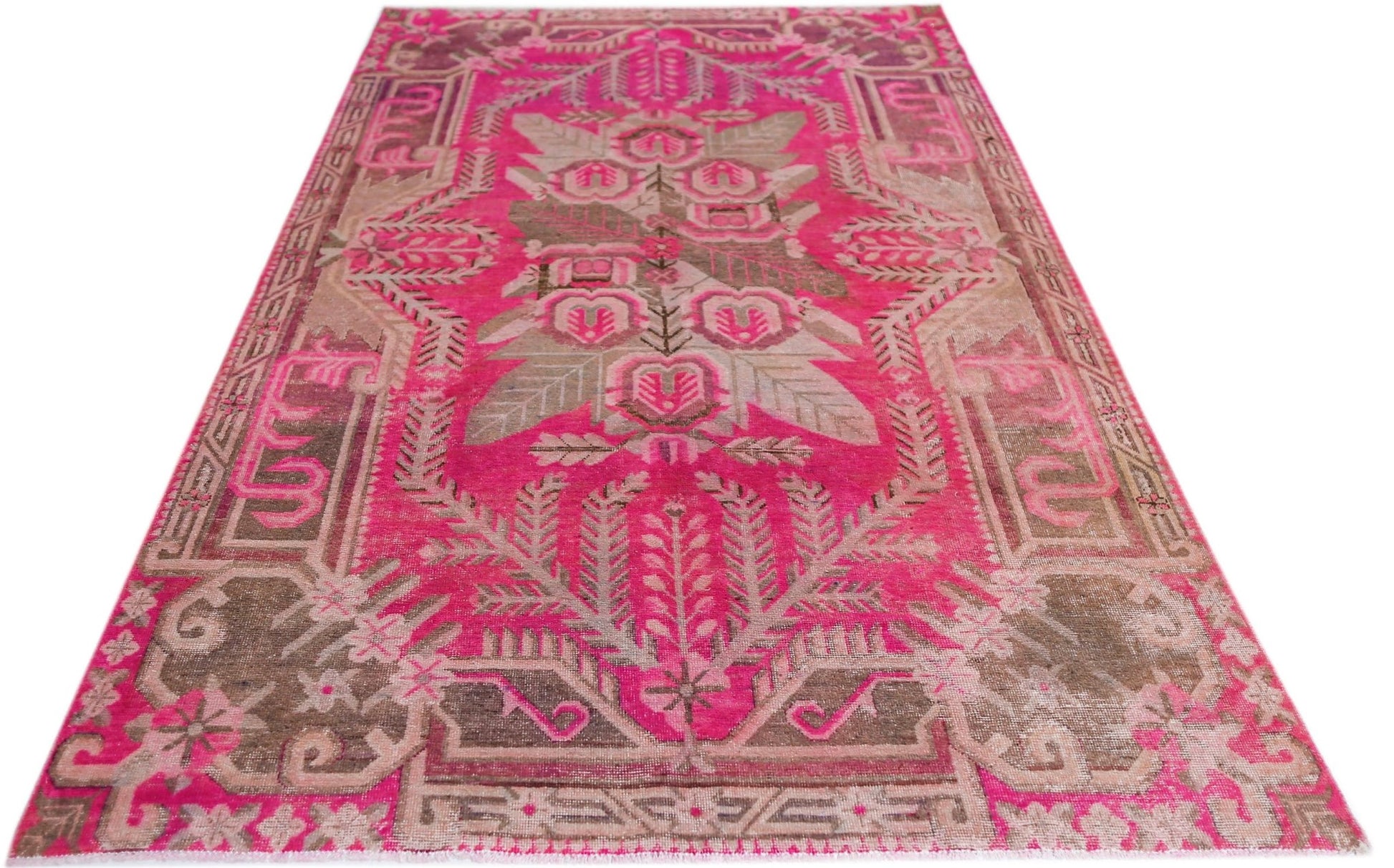 A vintage handwoven Khotan rug featuring an intricate pomegranate pattern in vibrant pink and brown.