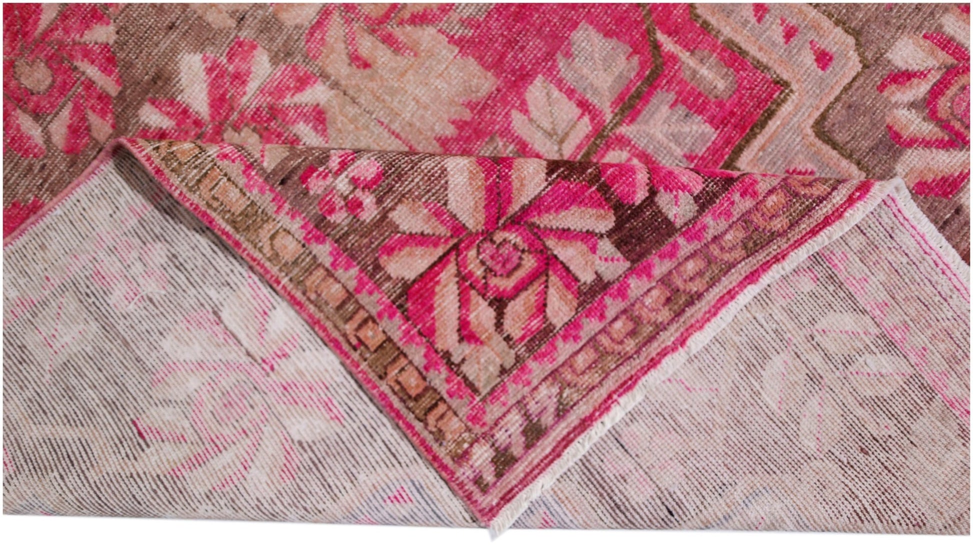 A vintage handwoven Khotan rug featuring an intricate pomegranate pattern in vibrant pink tones.