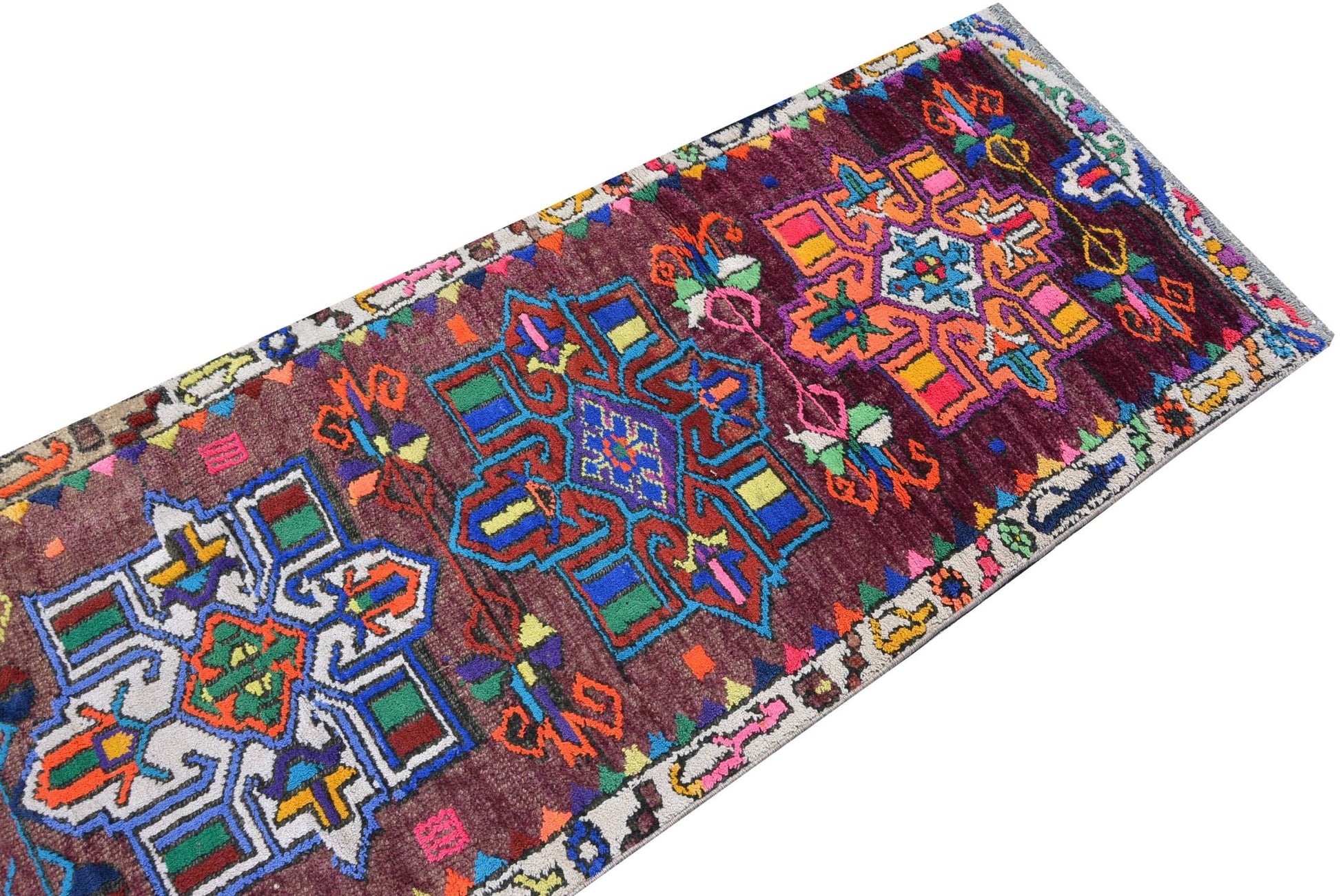 A vintage Kurdish Herki runner featuring tribal geometric motifs in vibrant neon colors.