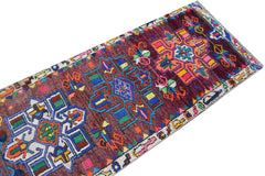 A vintage Kurdish Herki runner featuring tribal geometric motifs in vibrant neon colors.