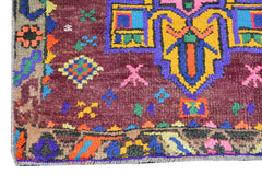 Vintage Kurdish Herki runner with colorful tribal motifs.