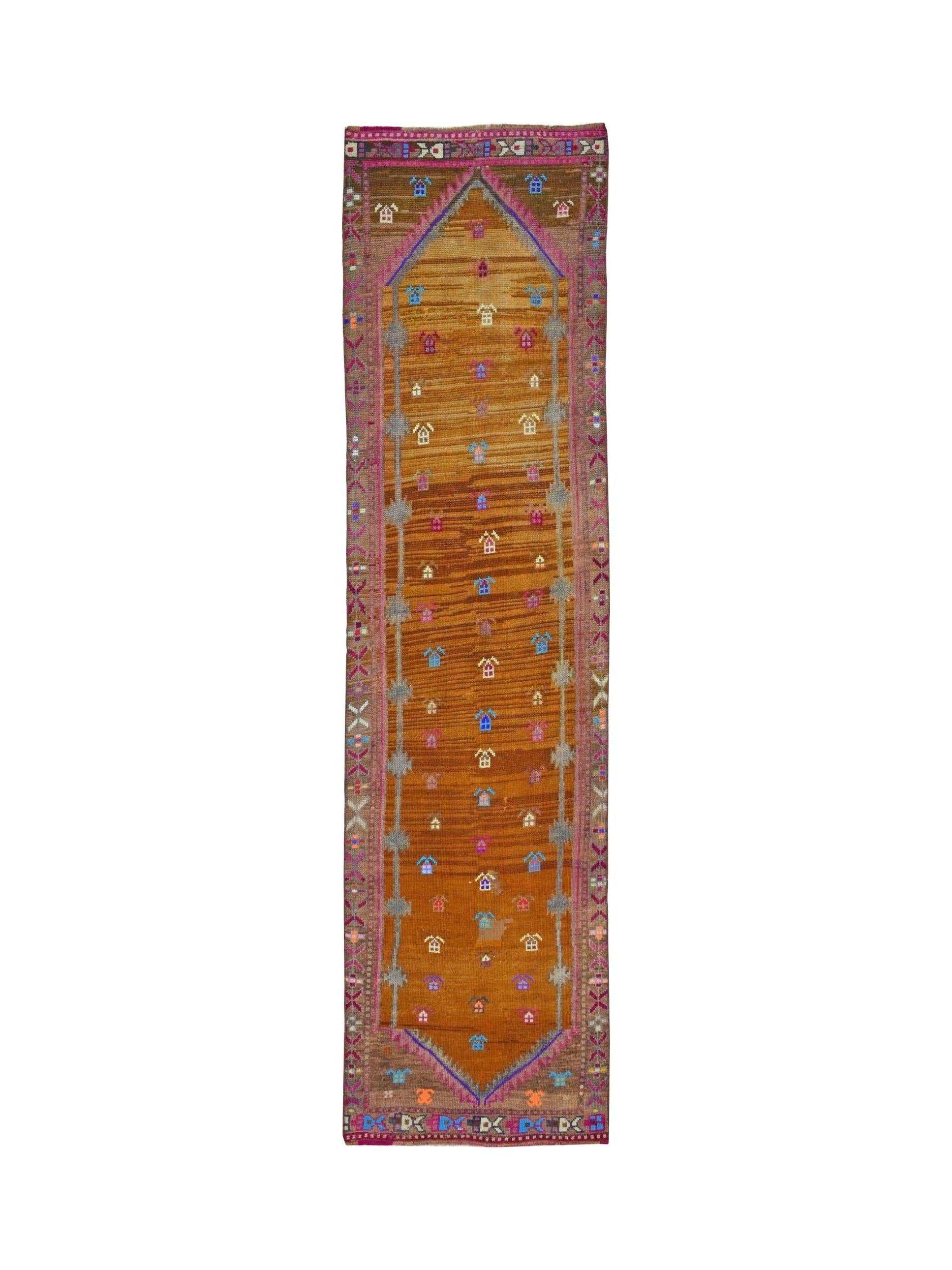 Vintage Kurdish Herki runner with tribal motifs and abrash color variation.