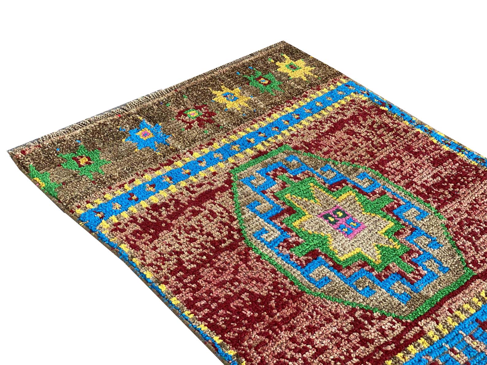A vintage Kurdish Herki runner featuring a geometric medallion in red, blue, green, and yellow.