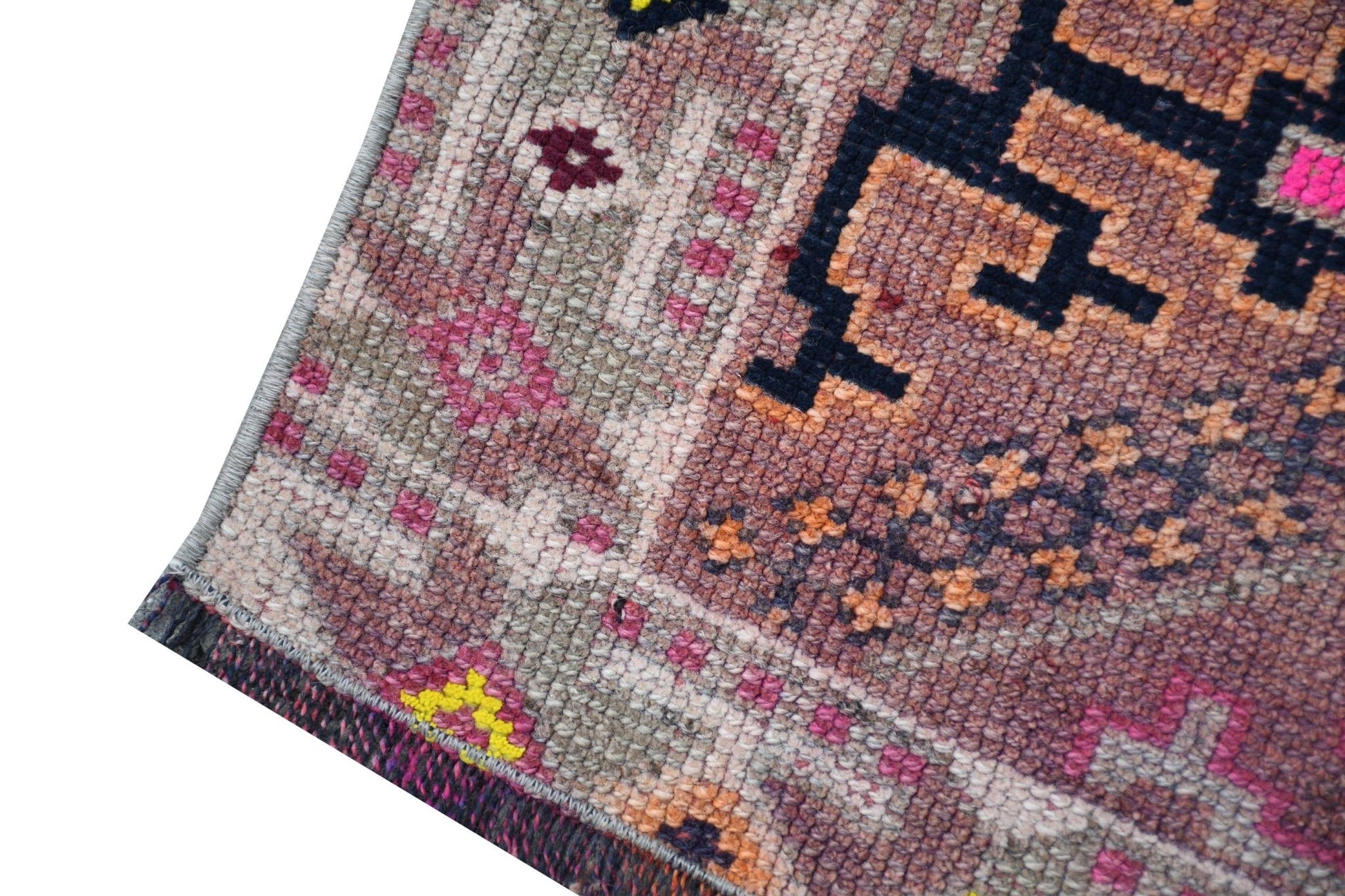 A vintage Kurdish Herki runner featuring tribal motifs in wool and neon nylon accents.