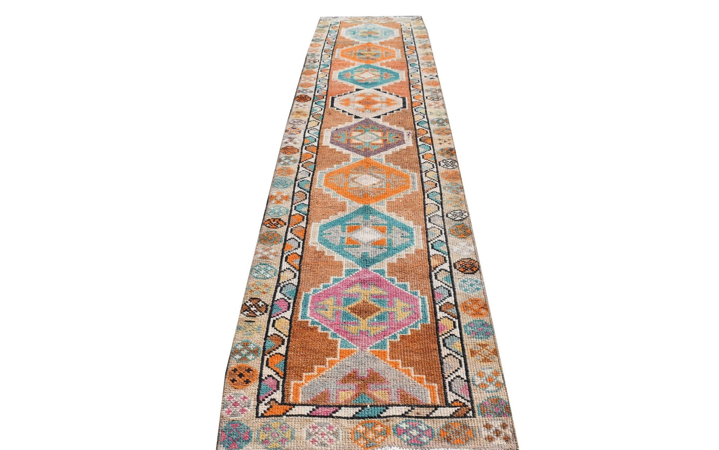 Vintage Kurdish Herki runner with geometric tribal patterns in orange, blue, and pink.
