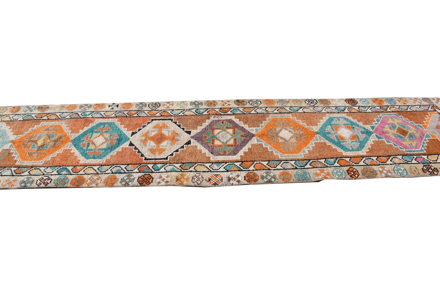 A vintage handmade Kurdish Herki runner featuring colorful geometric tribal motifs.