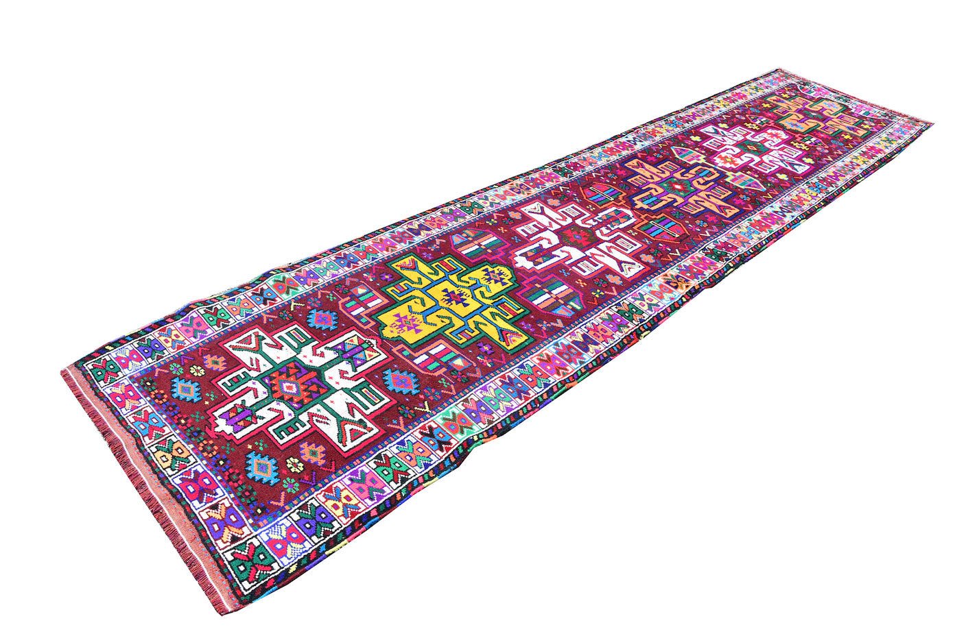 A vintage Kurdish Herki runner featuring vibrant tribal motifs on a deep red wool base.