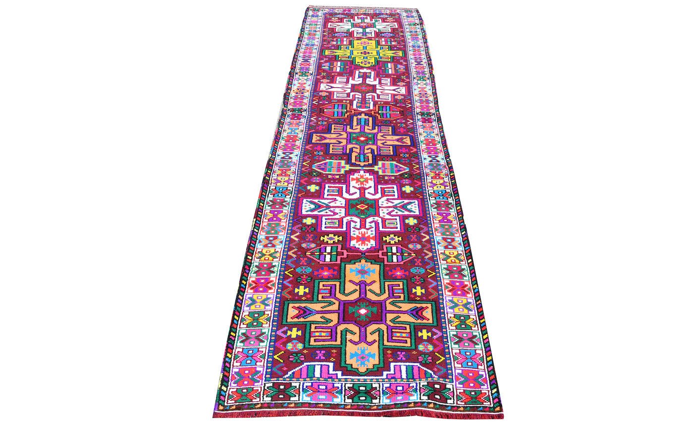 A vintage Kurdish Herki runner featuring vibrant tribal motifs in wool and neon nylon.