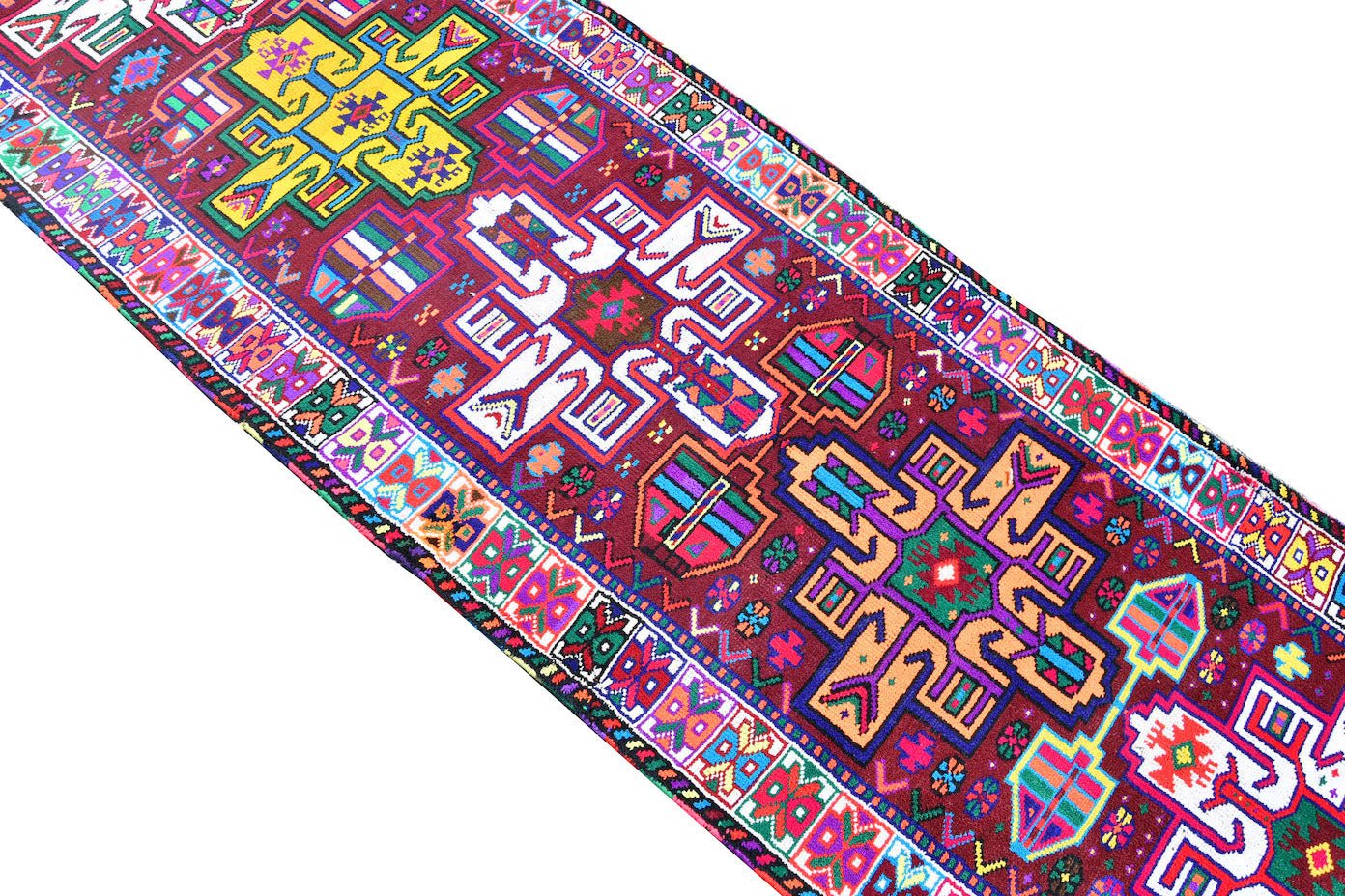 A vintage Kurdish Herki runner featuring vibrant tribal motifs in wool and neon nylon.