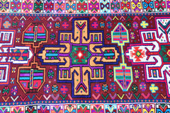 A vintage Kurdish Herki runner featuring vibrant tribal motifs in a bold, multicolored palette.