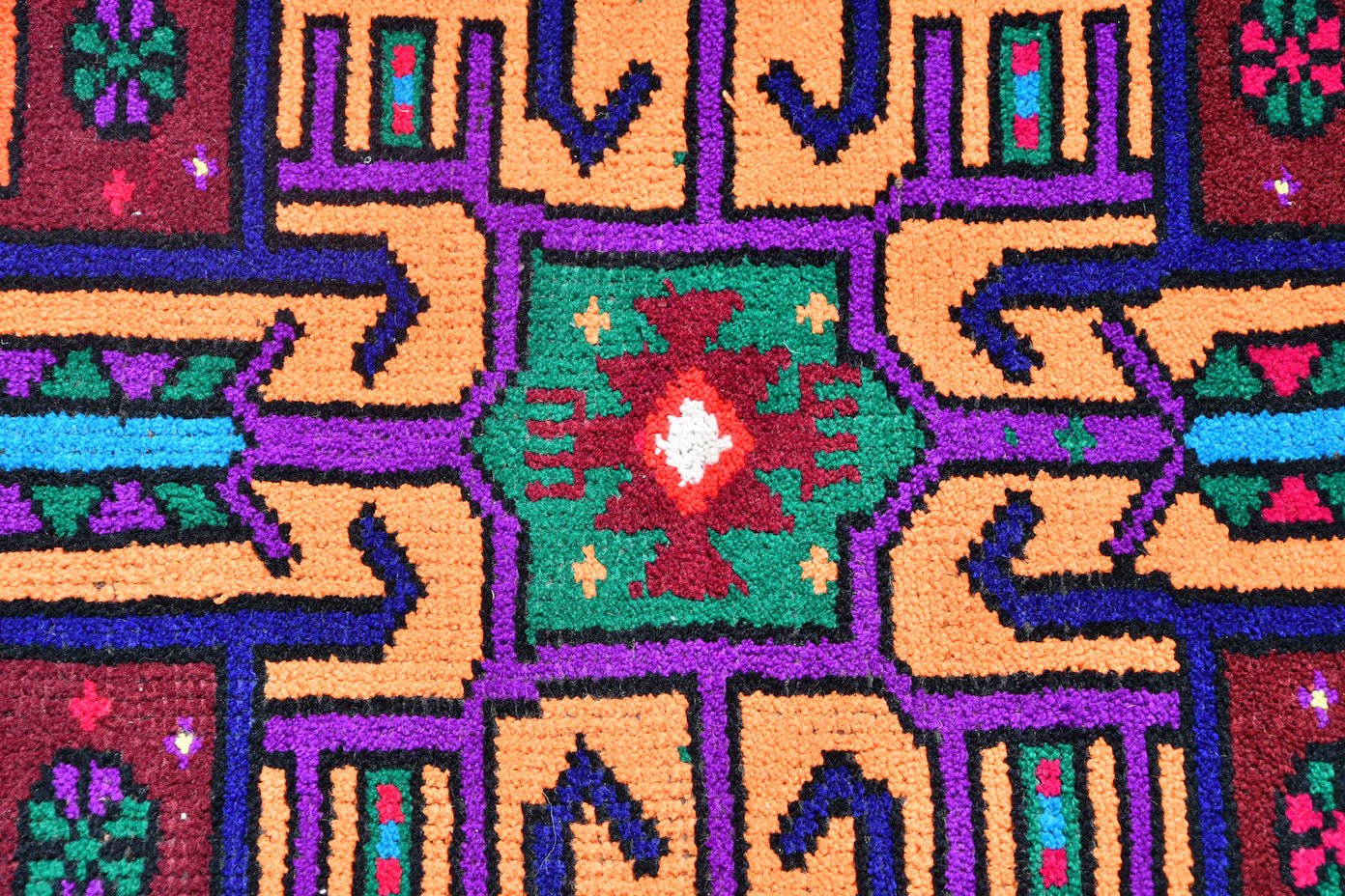 A vintage Kurdish Herki runner featuring vibrant tribal geometric patterns in wool and nylon.