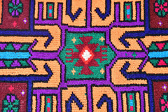 A vintage Kurdish Herki runner featuring vibrant tribal geometric patterns in wool and nylon.