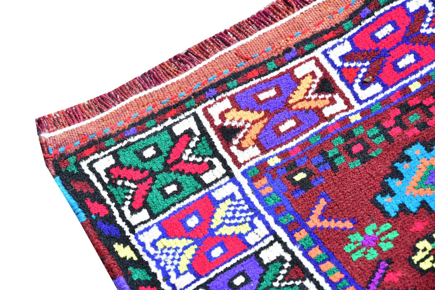 A vintage Kurdish Herki runner featuring vibrant tribal motifs in wool and nylon.