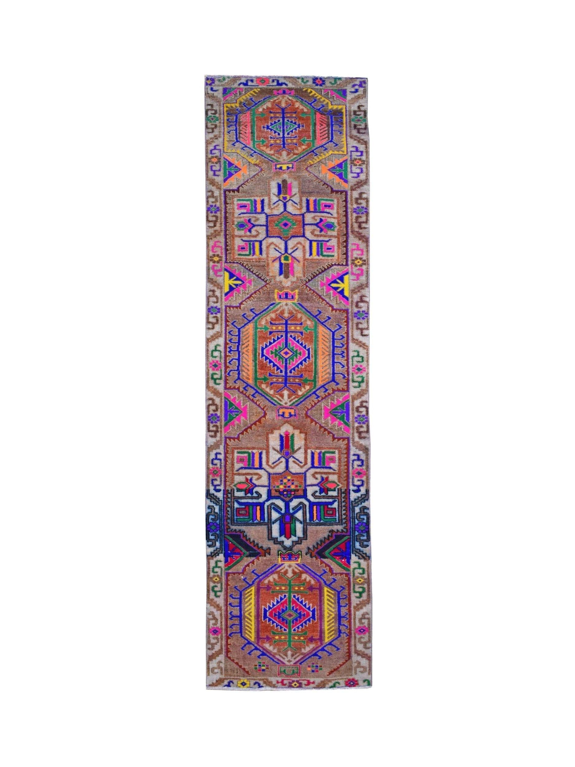 A vintage Kurdish Herki runner featuring vibrant tribal motifs on a brown wool base.