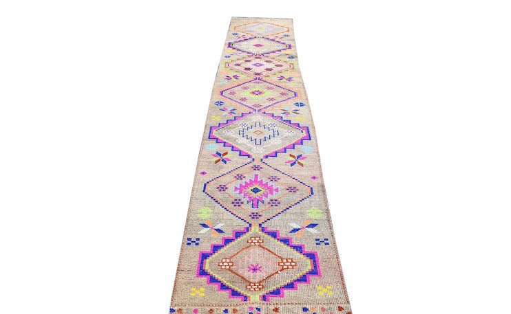 A vintage Kurdish Herki runner featuring a geometric diamond pattern in neon and wool tones.