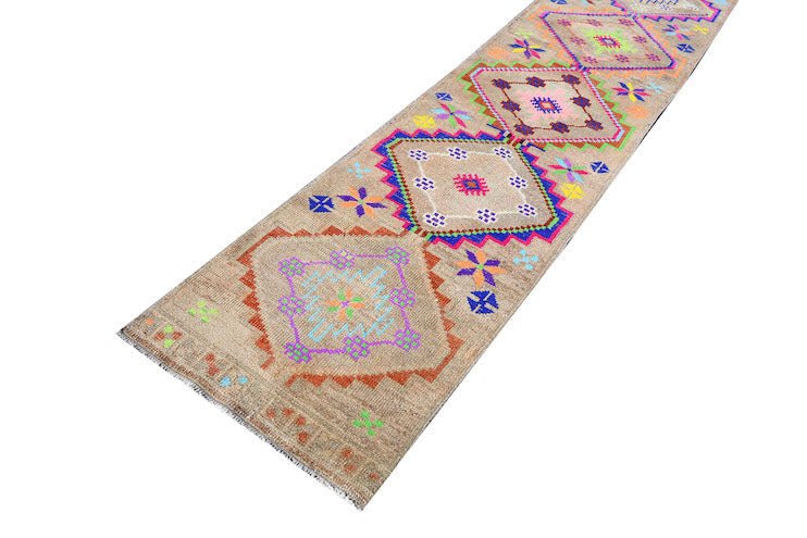 A vintage Kurdish Herki runner featuring tribal geometric motifs in vibrant neon colors.