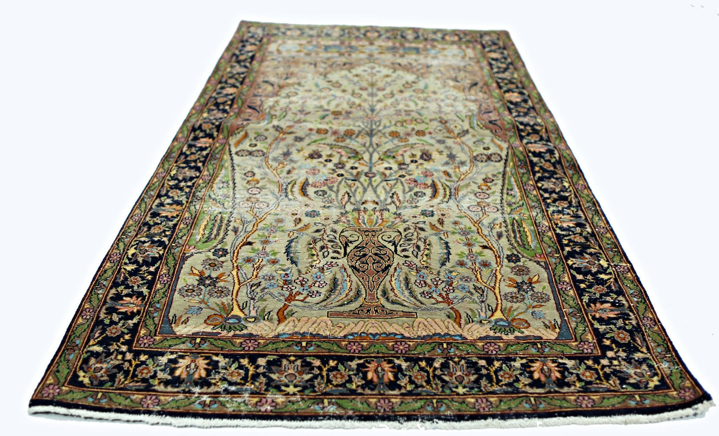A vintage handmade Persian prayer rug featuring a central vase and floral tree design.